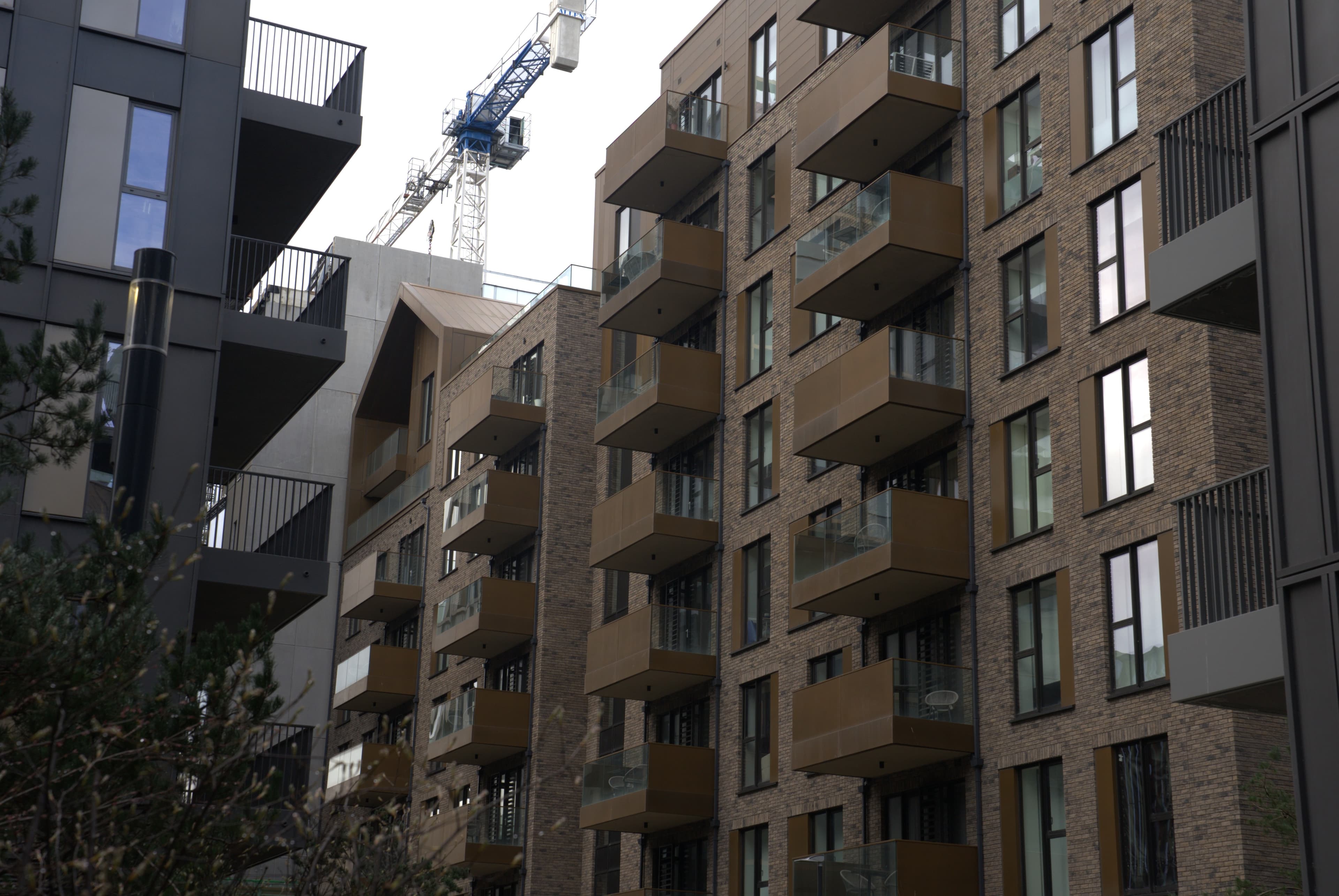 Street-level view of a Forte Pespa aluminium balcony facade under construction in London